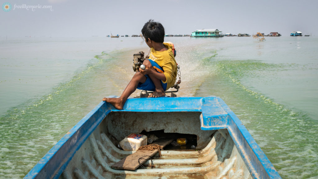 Boy Driving a Boat on Tonle Sap