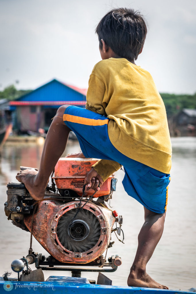 Boy Starting the Motorboat Tonle Sap