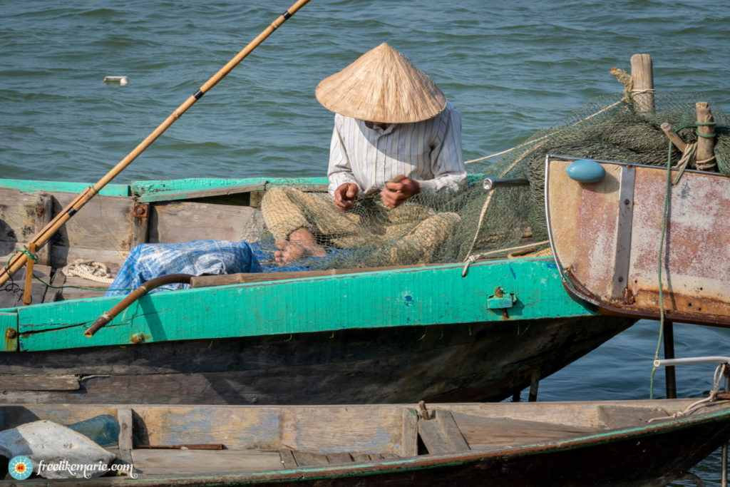 Fisherman Mending His Nets in Vietnam